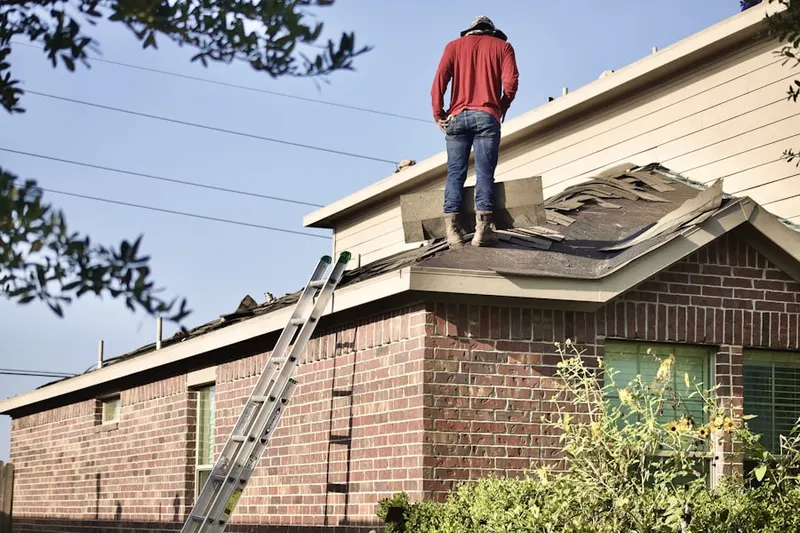 Professional roofer working on a residential roof in Salisbury Center